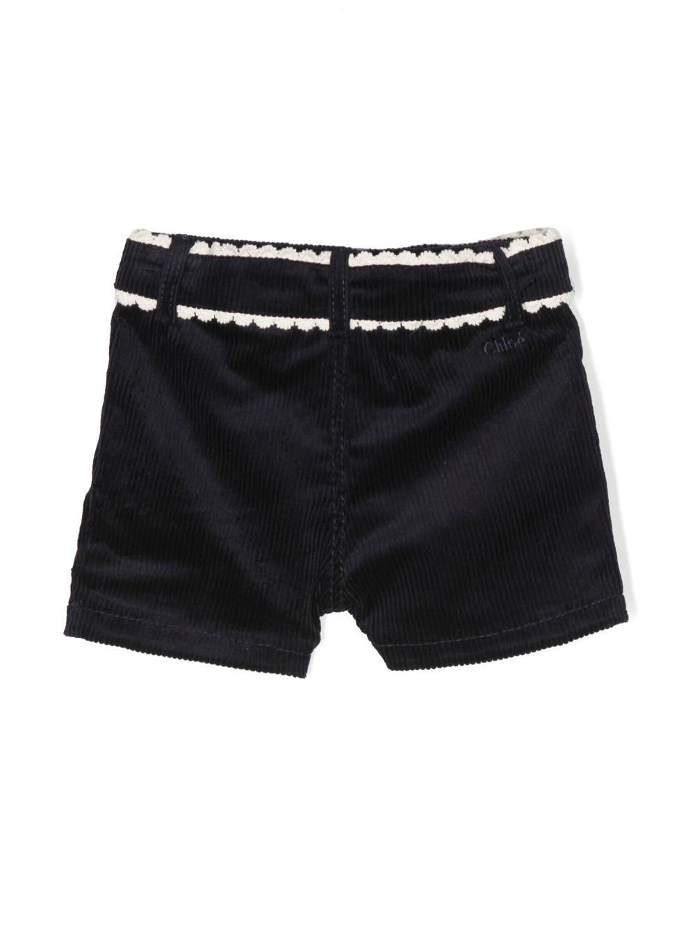 Shorts blu neonata con orlo a smerlo