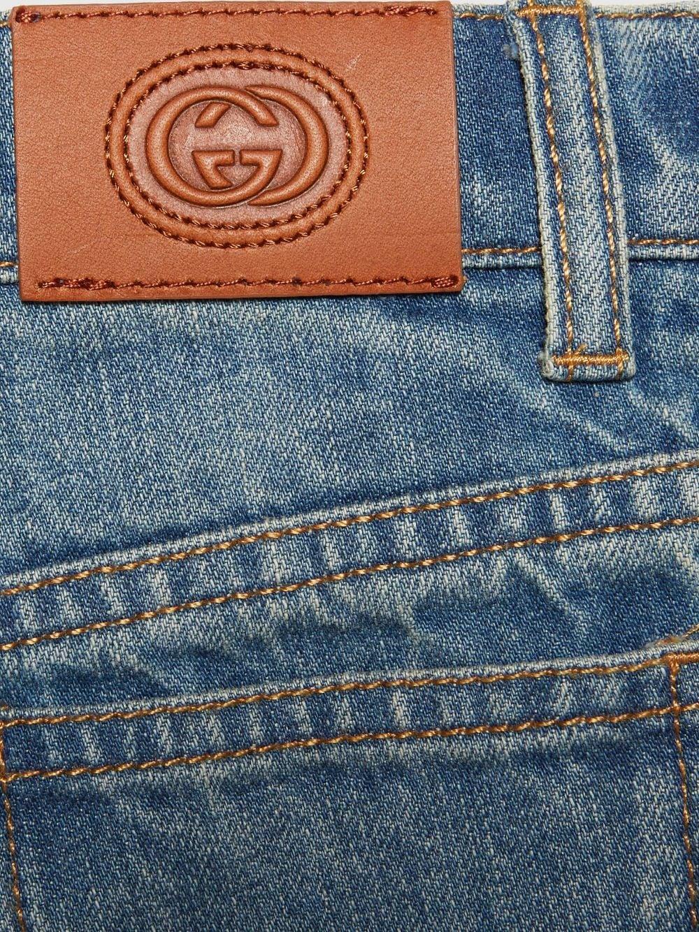 Boy's denim jeans with whisker effect, cotton, bleach wash, whisker effect, logo patch on back, pleated details, signature interlocking G logo, mid rise, straight leg, concealed fly and button fastening, belt loops, classic five pocket and hem straight
